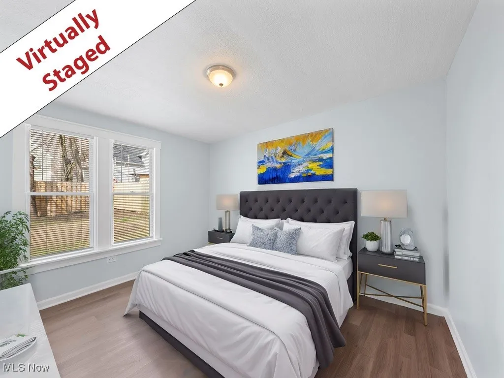 Bedroom featuring baseboards, wood finished floors, and a textured ceiling