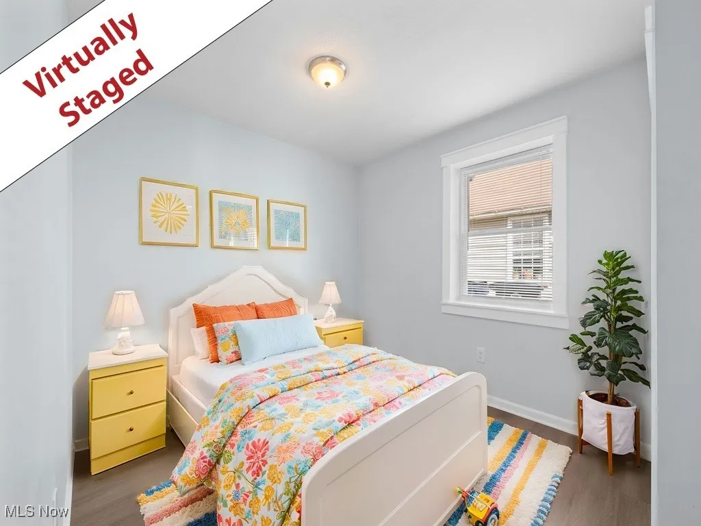 Bedroom with baseboards and wood finished floors