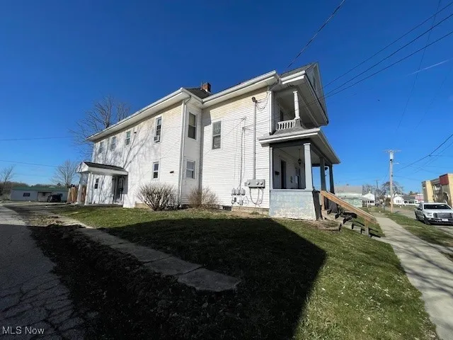 View of property exterior with a yard