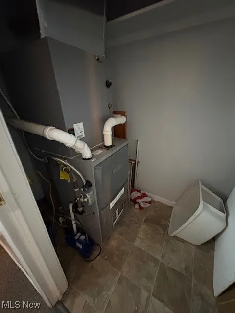 Utility room featuring heating unit