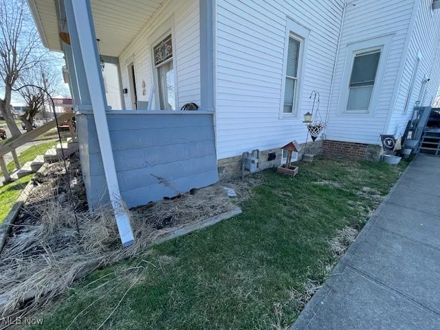 View of side of property with a yard