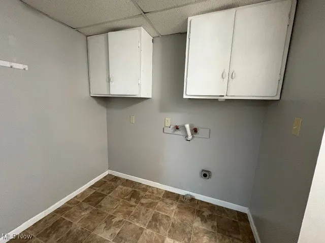 Laundry room featuring cabinet space, electric dryer hookup, and washer hookup