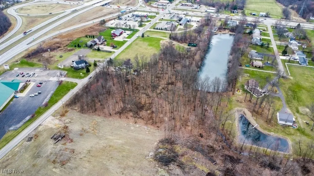 Birds eye view of property with a water view
