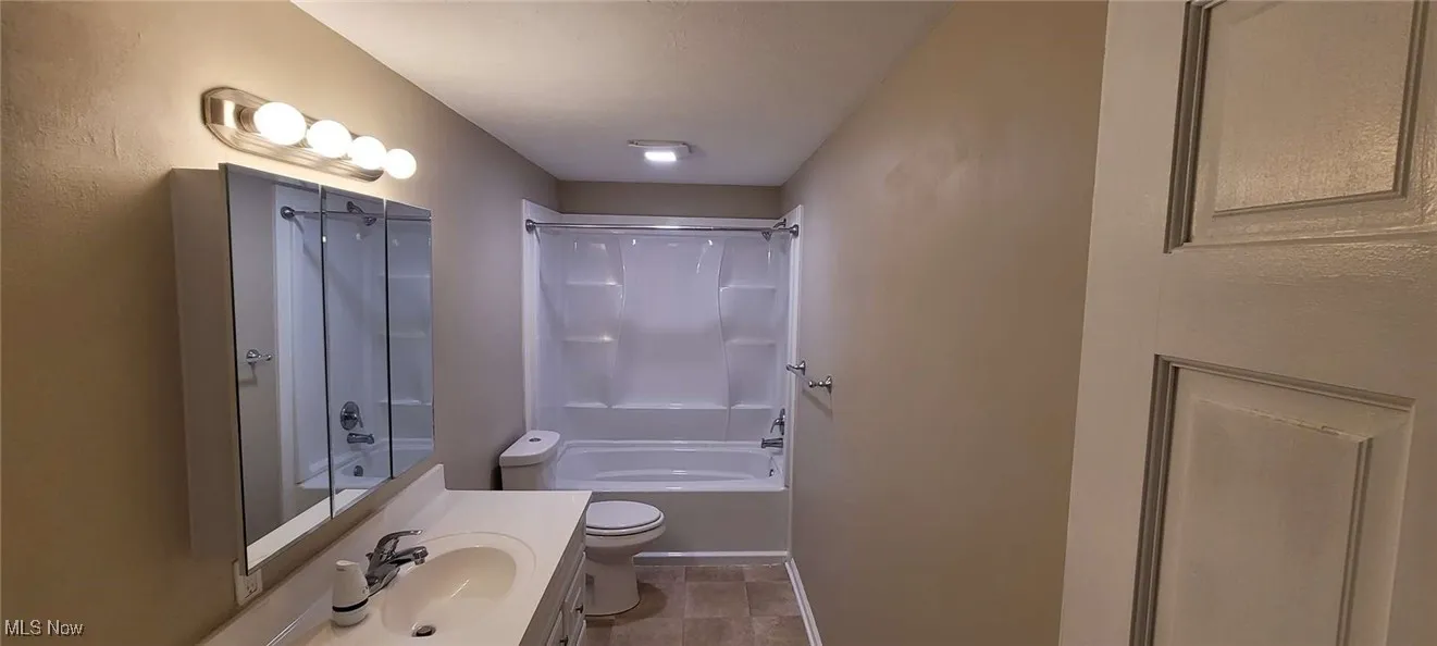 Full bath featuring  shower combination and vanity
