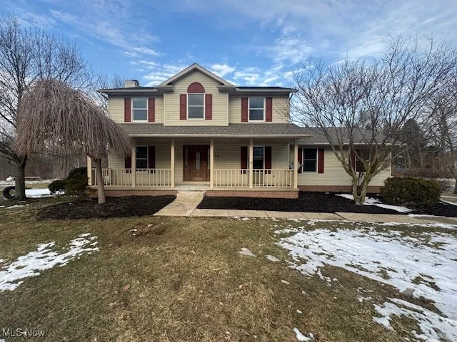 View of front of home with a porch and a chimney
