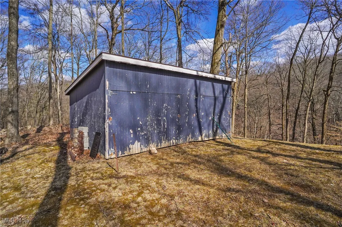 View of outdoor structure with an outbuilding