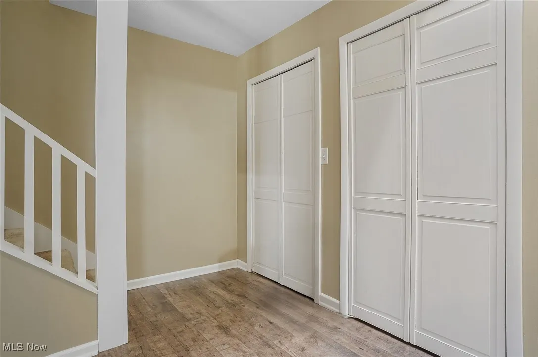 Unfurnished bedroom featuring baseboards and wood finished floors