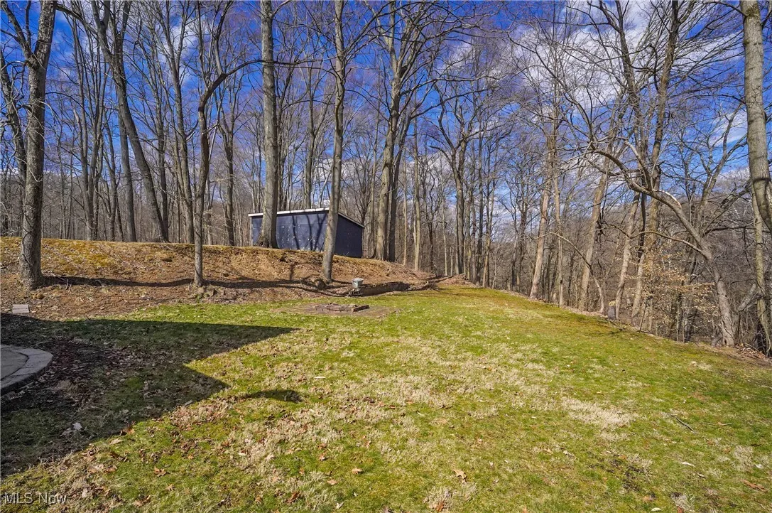 View of yard featuring a forest view