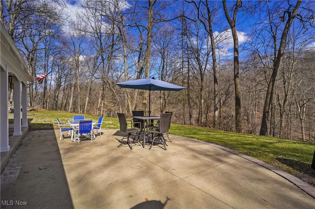 View of patio / terrace with outdoor dining area and a forest view