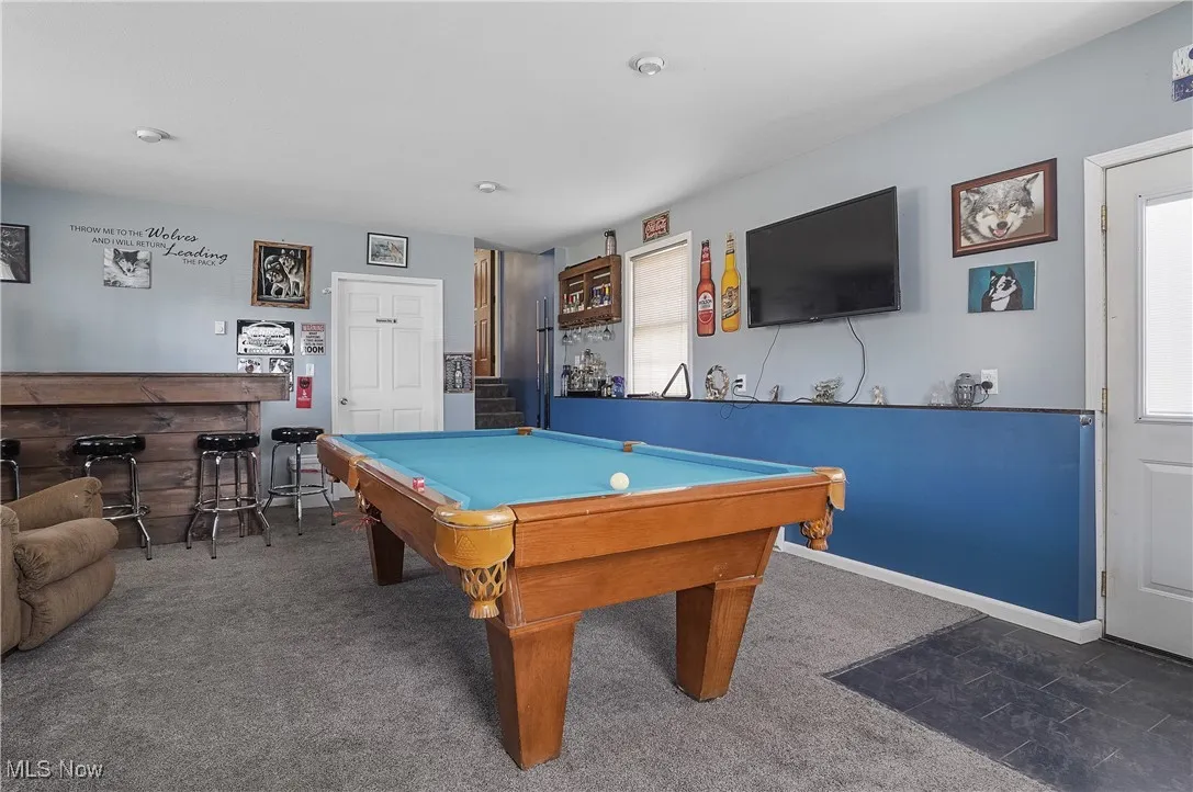 Rec room featuring baseboards, a dry bar, carpet flooring, and billiards