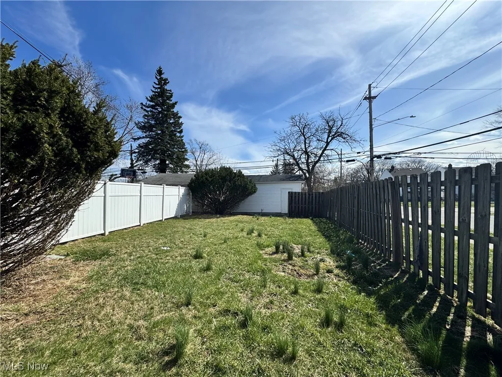View of yard featuring an outbuilding and a fenced backyard