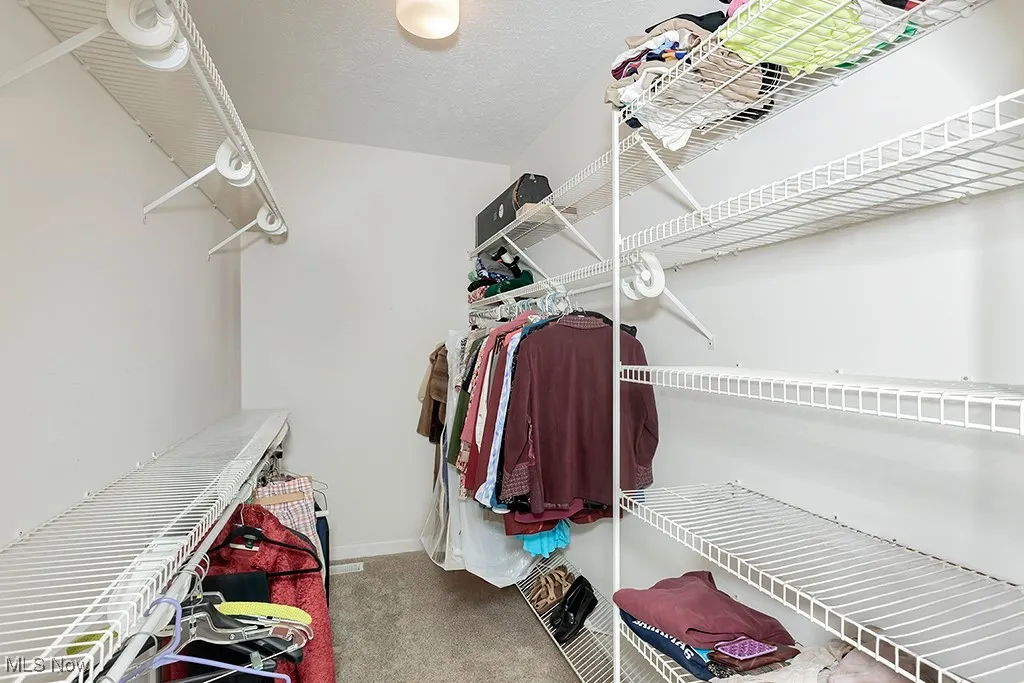 Walk in closet in primary bedroom