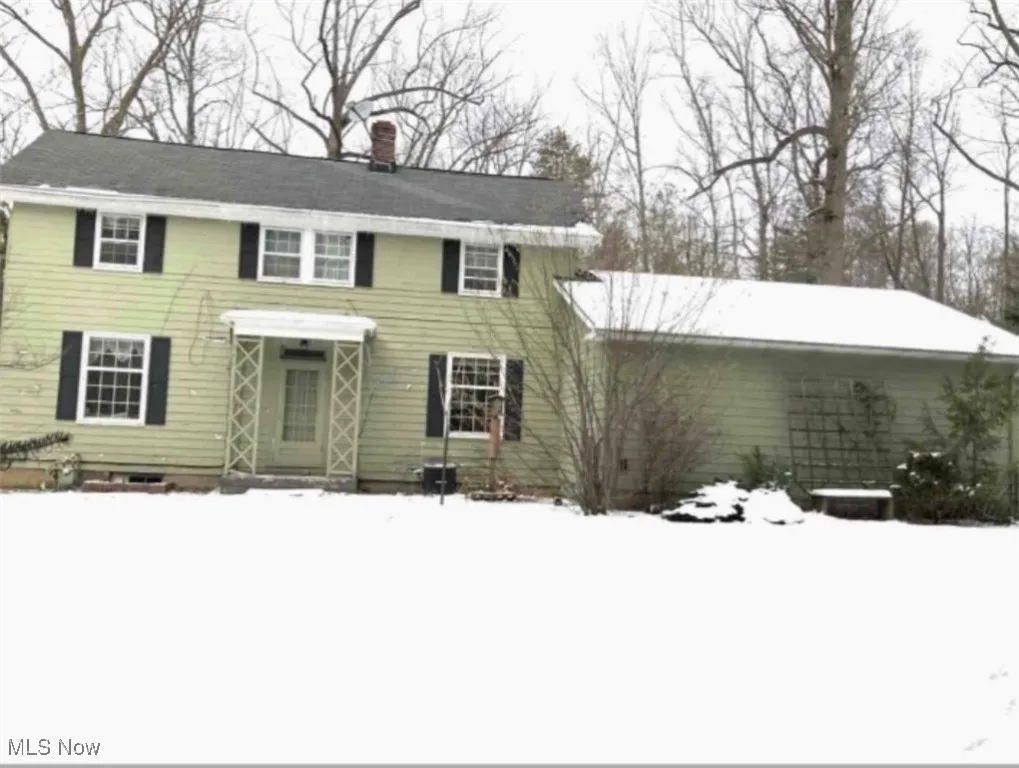 Colonial home featuring a chimney