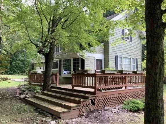 Rear view of house featuring a deck