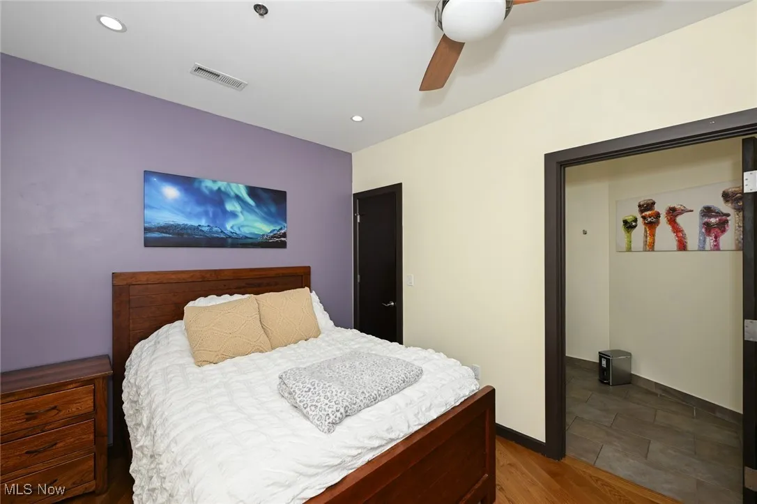 Bedroom featuring recessed lighting, baseboards, visible vents, a ceiling fan, and wood finished floors