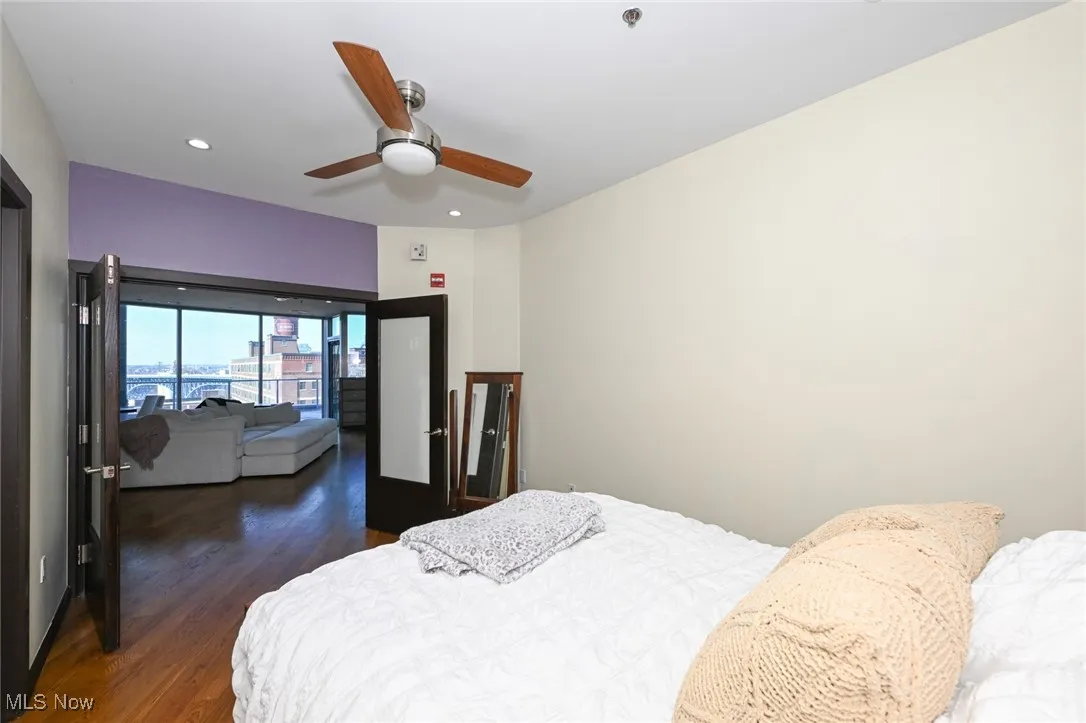 Bedroom with wood finished floors, recessed lighting, and a ceiling fan