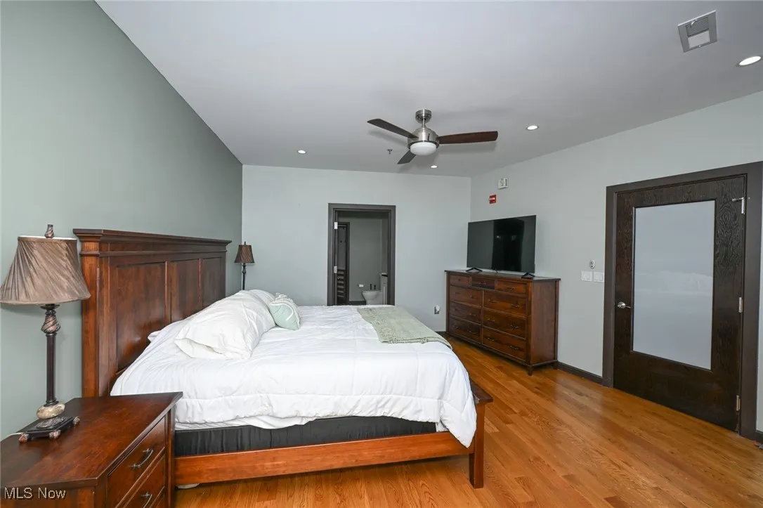 Bedroom with recessed lighting, baseboards, visible vents, a ceiling fan, and wood finished floors
