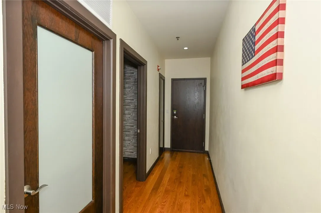 Corridor featuring wood finished floors