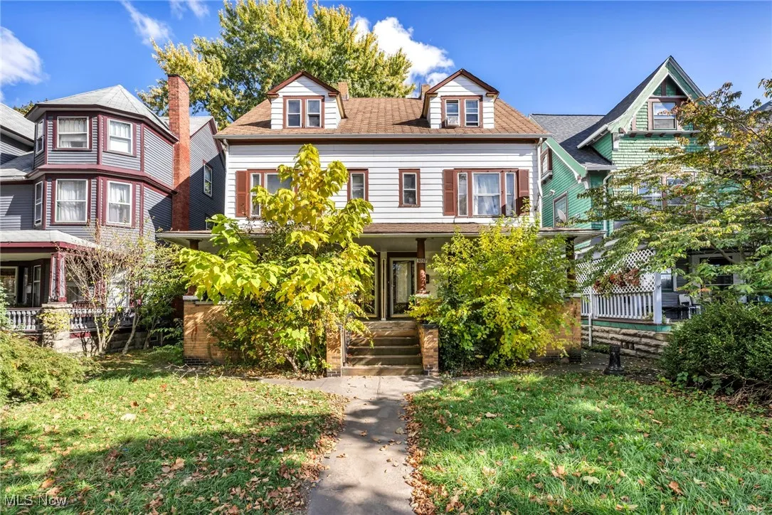 View of front of home featuring a front yard and roof with shingles