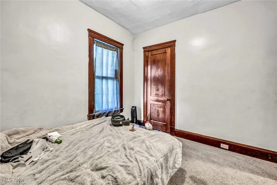 Bedroom featuring baseboards and carpet flooring