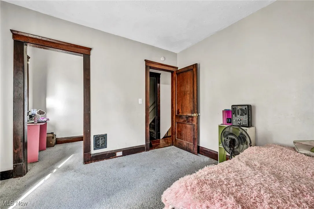 Bedroom featuring baseboards, visible vents, and carpet floors