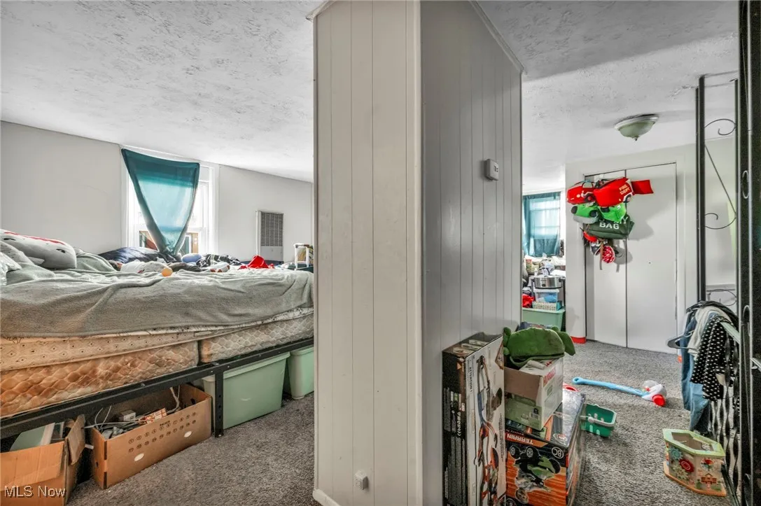 Bedroom with carpet flooring and a textured ceiling