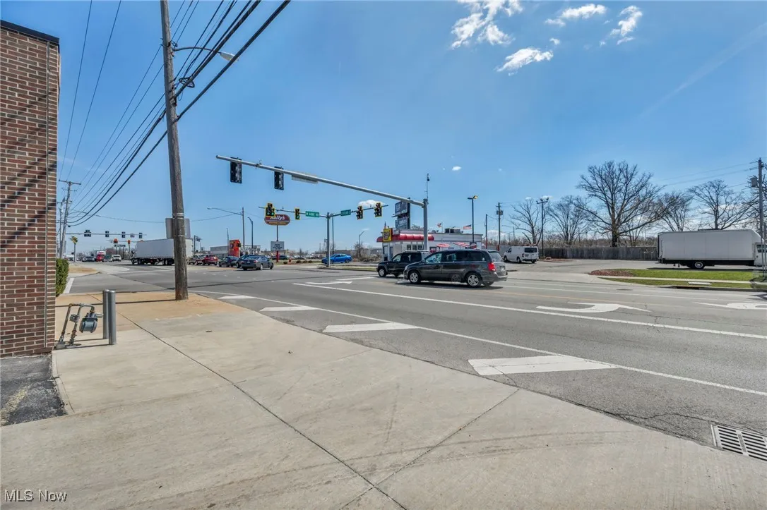 View of road featuring sidewalks and traffic lights