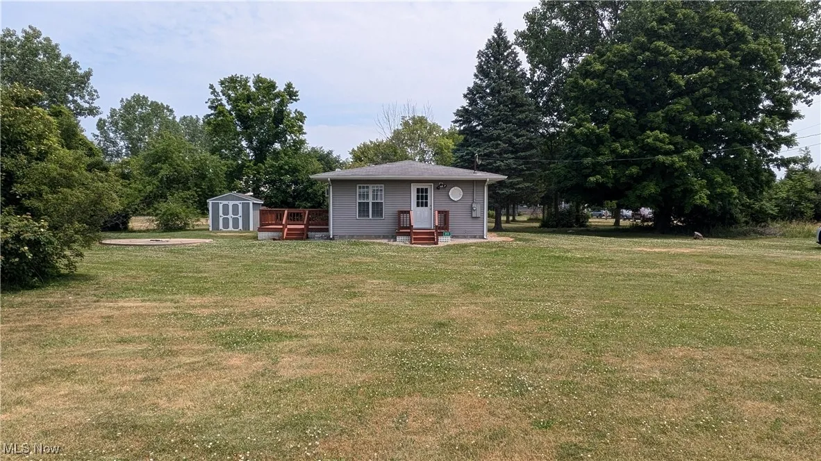 View of yard with an outbuilding and a storage unit