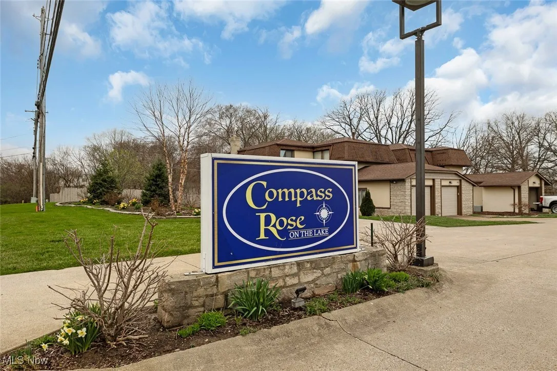 Community sign with driveway and a yard