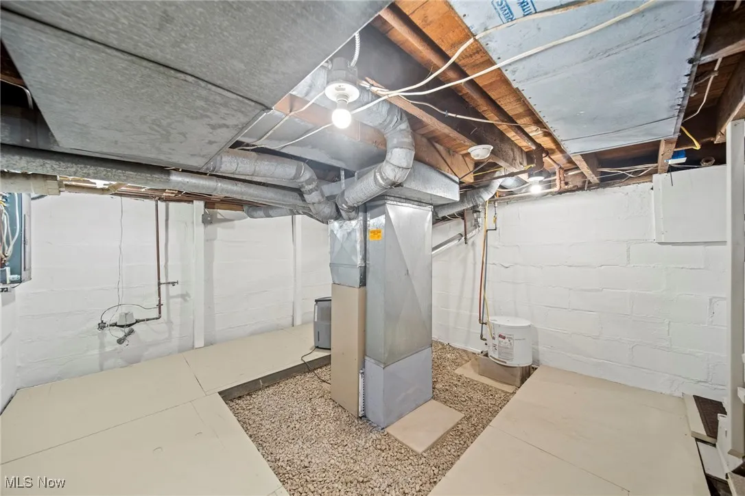 Unfinished basement featuring heating unit