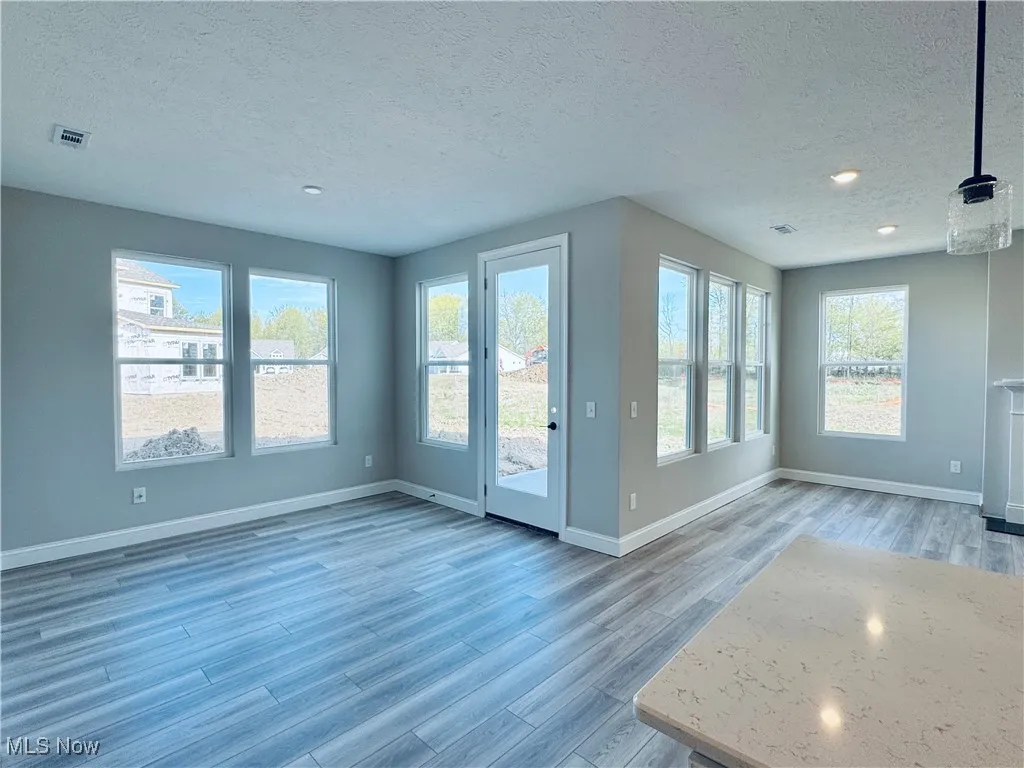 Numerous windows overlooking the rear yard and patio
