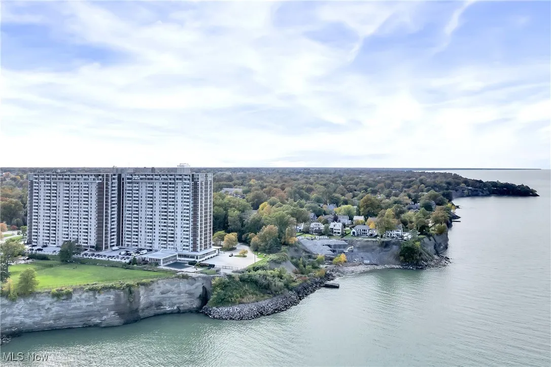 Birds eye view of property with a water view