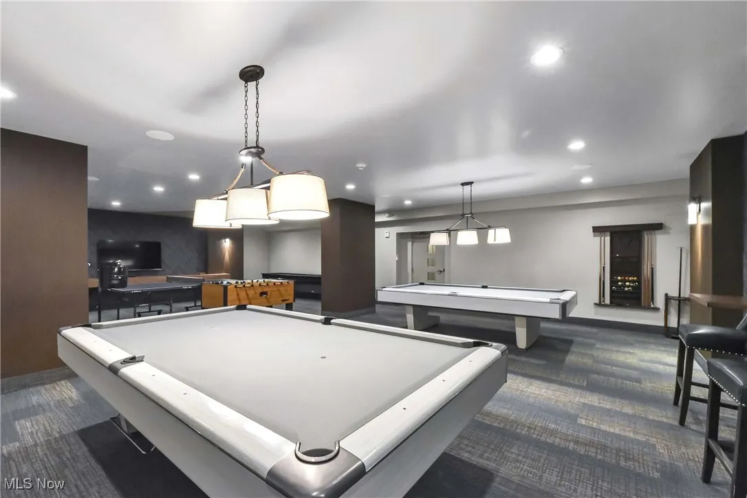 Recreation room with carpet flooring, baseboards, pool table, and recessed lighting
