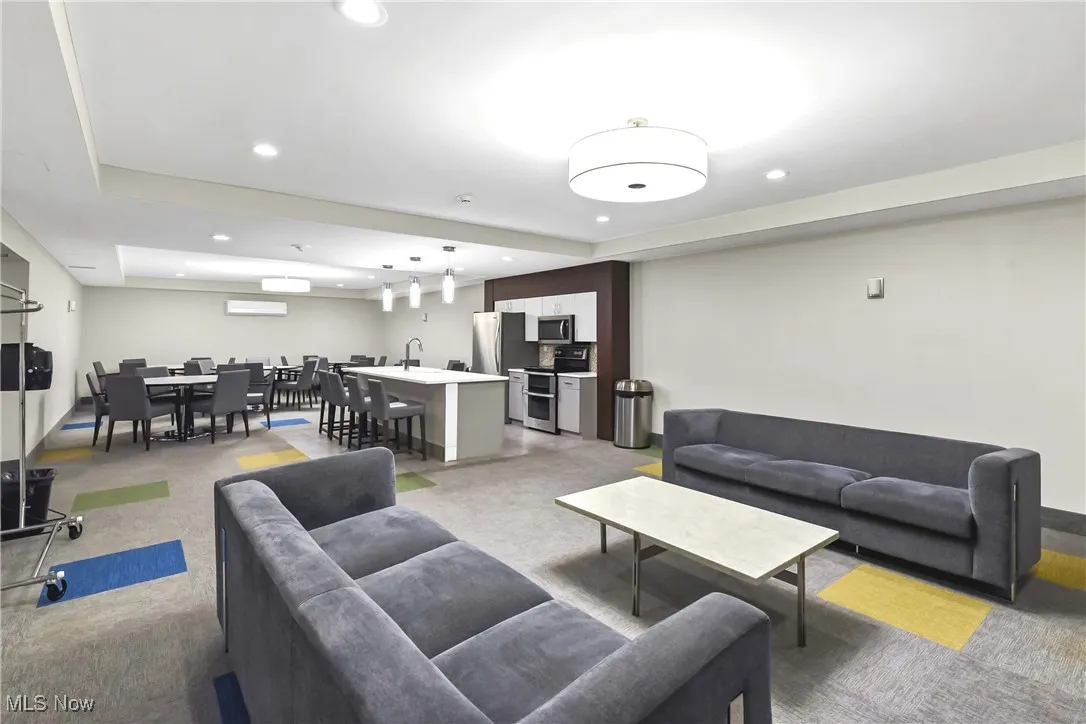 Living room featuring a community bar and recessed lighting