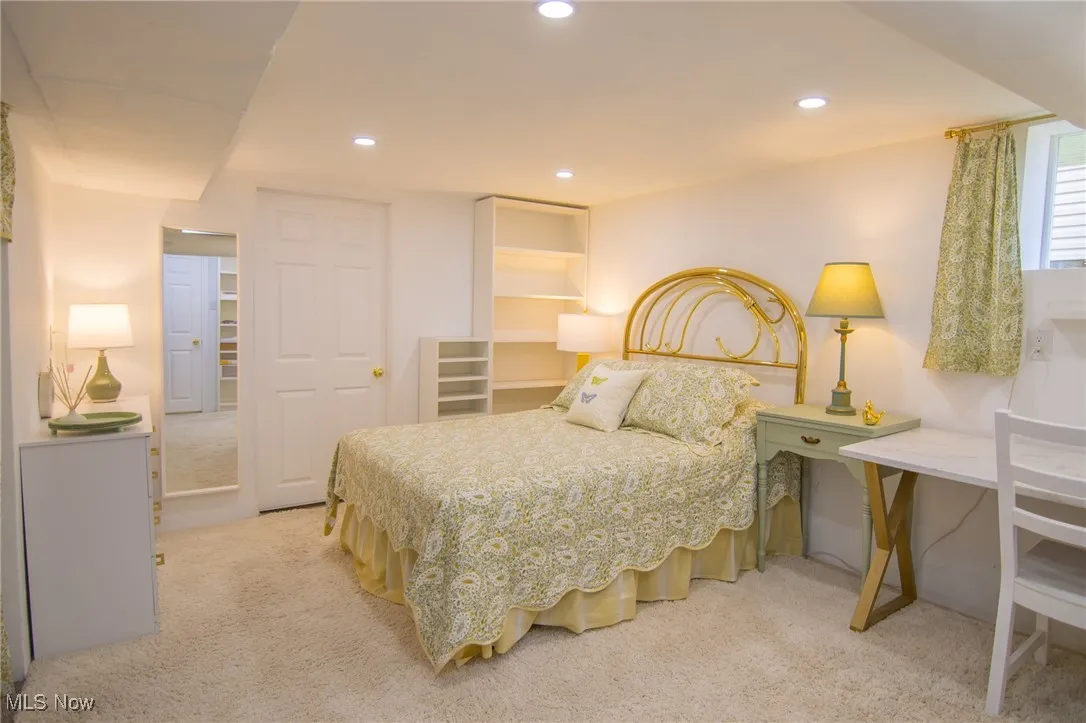 Bedroom with recessed lighting and light carpet