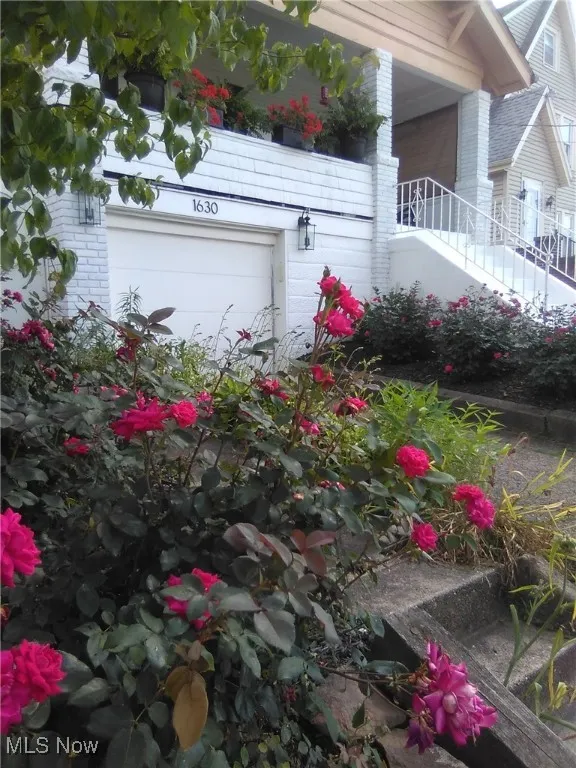 View of home's exterior with brick siding and a garage