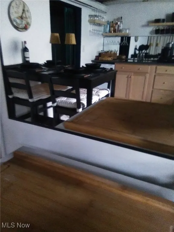 Dining area featuring bar area and wood finished floors