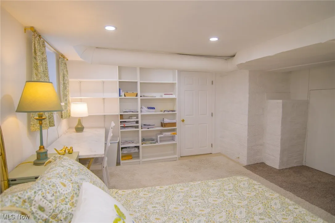 Carpeted bedroom with recessed lighting