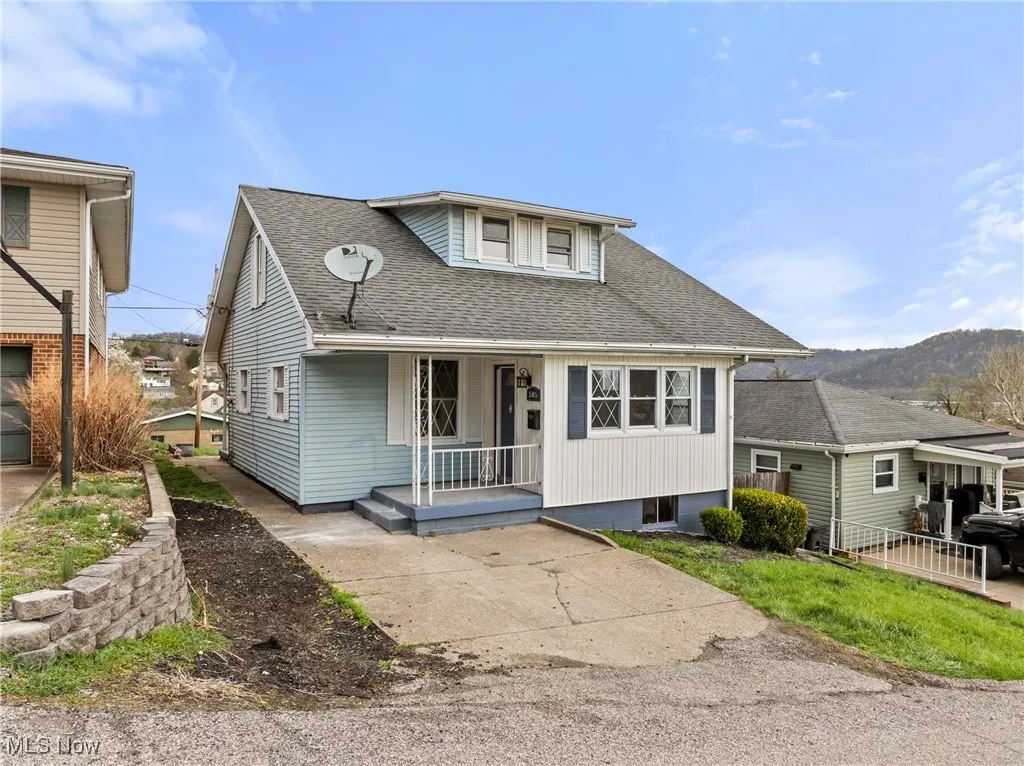 Bungalow featuring a porch and roof with shingles