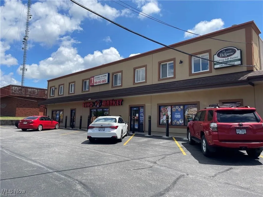 View of building exterior with uncovered parking