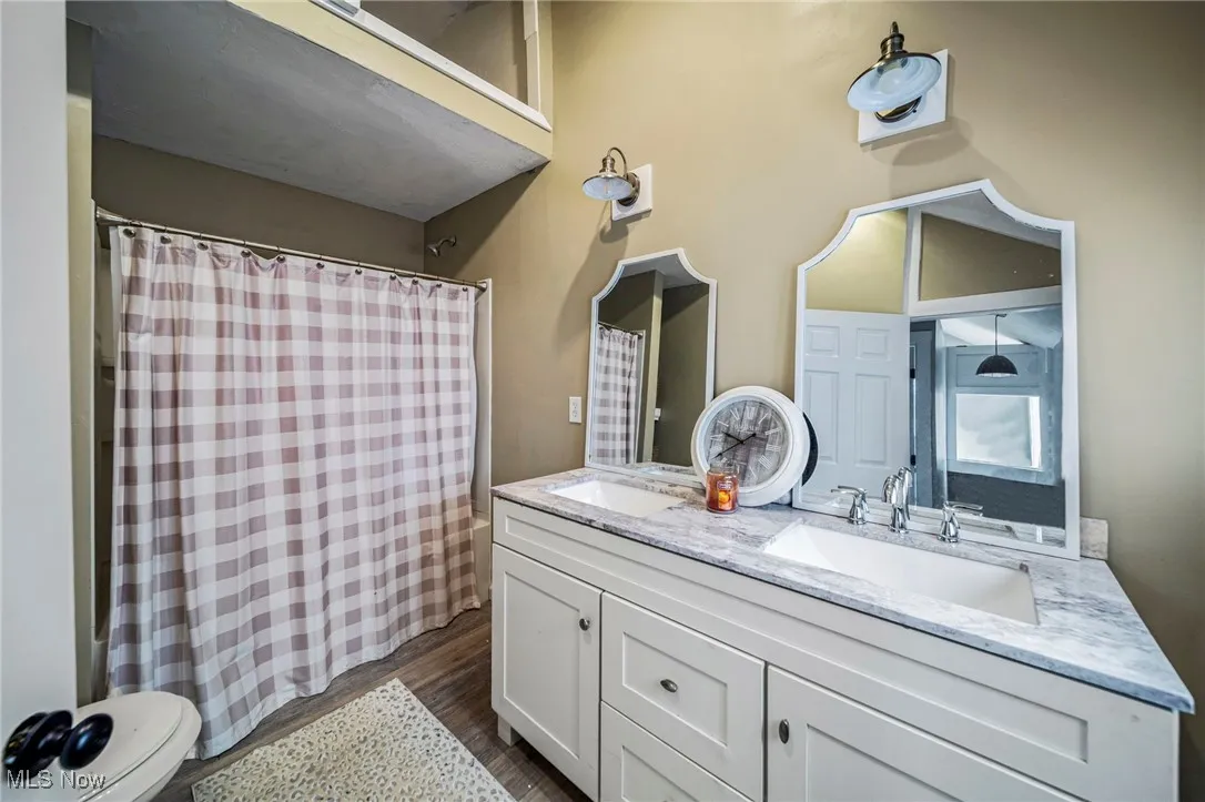 Bathroom featuring double vanity, a sink, a shower and bath tub