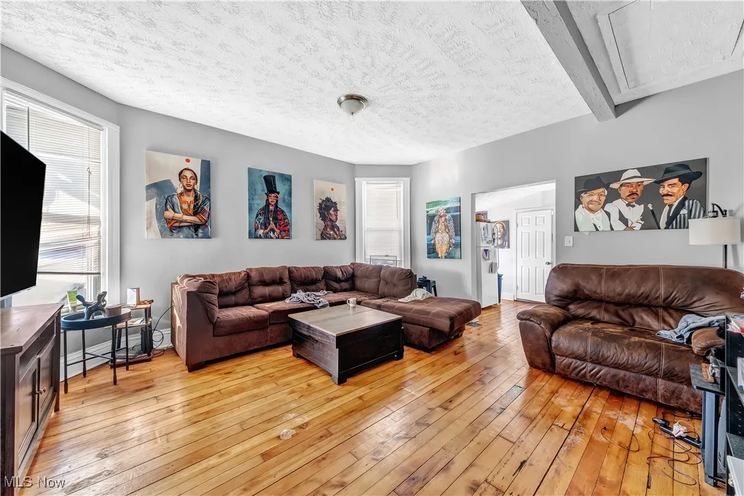 Living room featuring a textured ceiling and light wood-type flooring