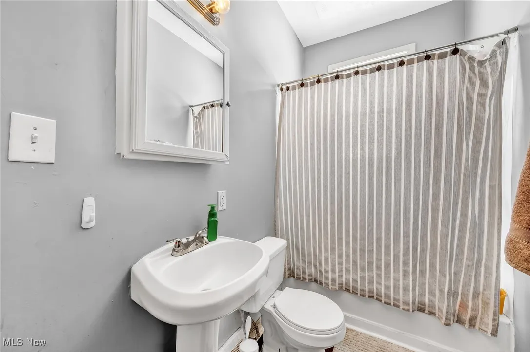 Full bathroom featuring a sink and toilet