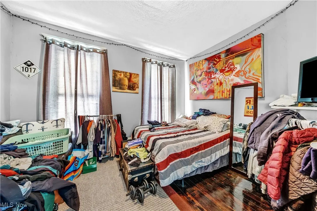 Bedroom with wood finished floors and a textured ceiling