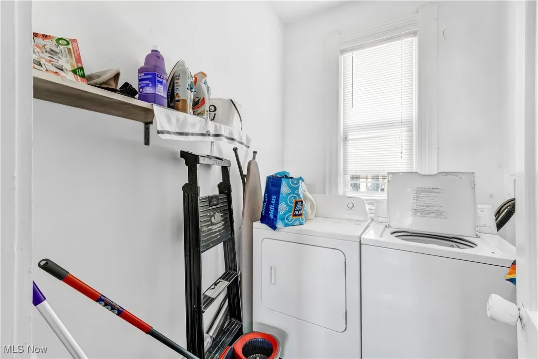 Clothes washing area featuring laundry area and separate washer and dryer