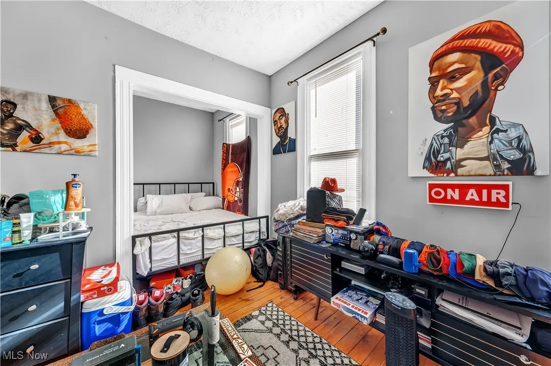 Bedroom featuring a textured ceiling and wood-type flooring
