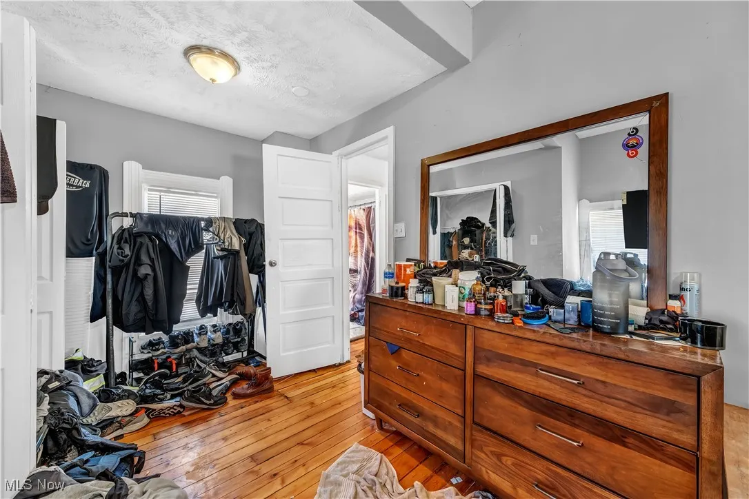 Bedroom featuring a textured ceiling and light wood-style floors