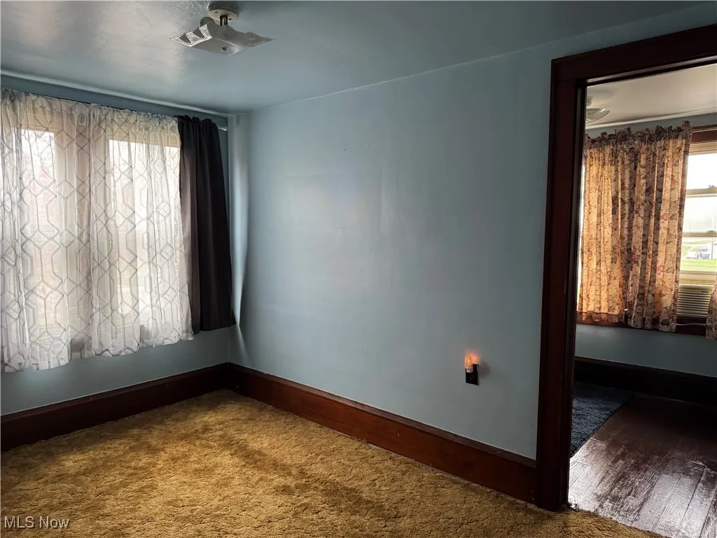 Unfurnished room with baseboards
