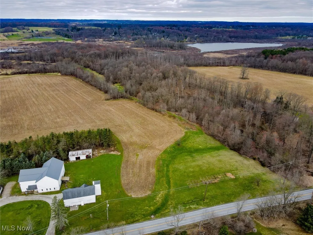 Bird's eye view featuring a water view, a view of trees, and a rural view