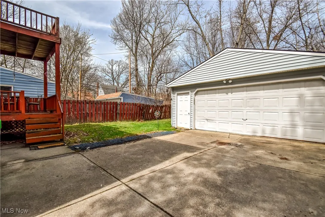 Detached garage featuring fence